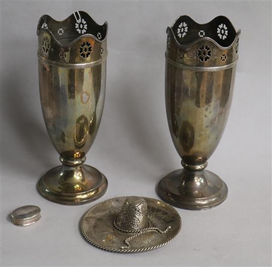 A pair of George V silver vases, Birmingham, 1922, a white metal model of a gaucho hat and a silver pill box.